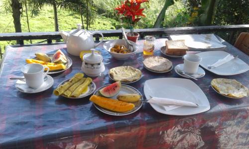 a blue table with plates of food on it at Broad view in Ella