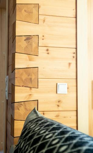 a room with a wooden wall with a bed at Riverside luxury suites in Rovaniemi