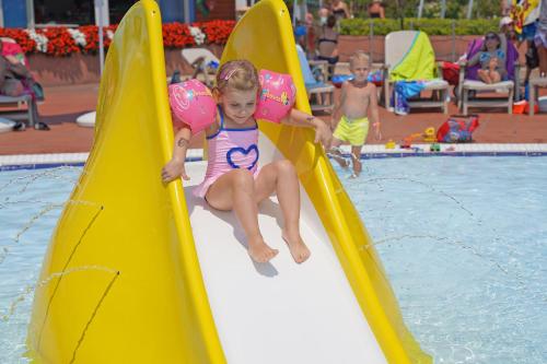 a little girl on a slide in a swimming pool at San Francesco Camping Village in Desenzano del Garda