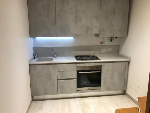 a kitchen with a sink and a stove top oven at APPARTAMENTI del DUCA in Ferrara