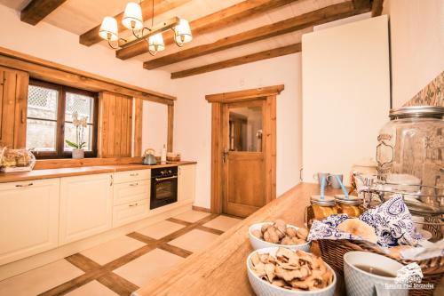 a kitchen with a counter with bowls of food on it at Ranczo Pod Strzechą in Stara Kamienica