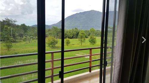 a window with a view of a mountain at Sheridan Organic Farm and Resort in Maratapi