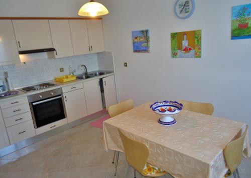 a kitchen with a table with a bowl on it at Apartment Gioia in Savudrija
