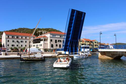 a group of people in a boat in the water at Apartments Maria in Tisno