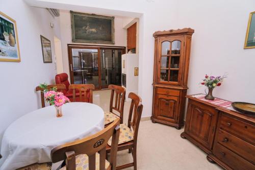 a living room with a table and chairs and a kitchen at Villa Ana in Savudrija