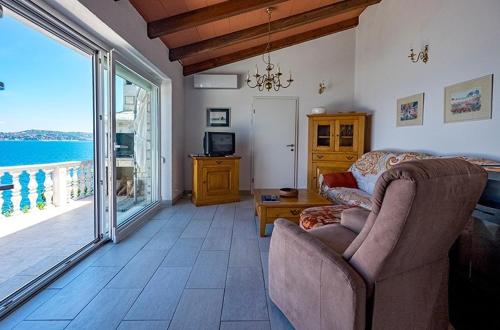 a living room with a couch and a view of the ocean at Villa Ana in Savudrija