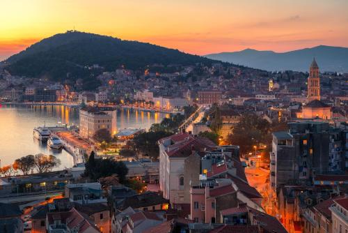 a view of a city with a river and buildings at Royal Suites-Sky in Split
