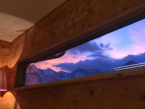 a window in a room with a mountain view at Chalet Safran in Grächen