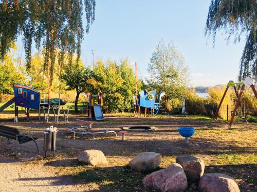 a park with playground equipment and rocks and trees at Hotel Prinz Heinrich in Werder