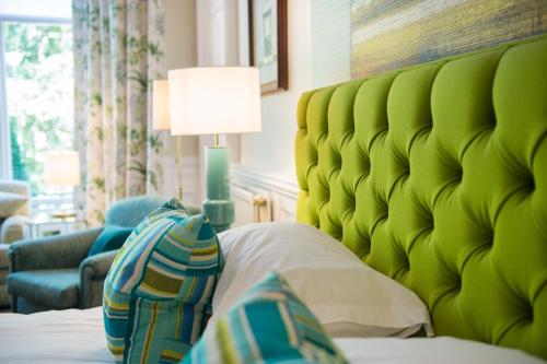 a bed with a green headboard in a room at One Devonshire Gardens a Hotel Du Vin in Glasgow