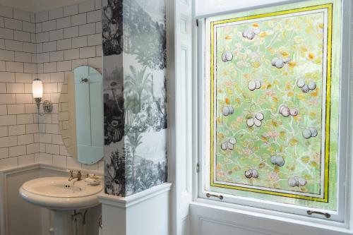 a bathroom with a sink and a shower curtain at One Devonshire Gardens a Hotel Du Vin in Glasgow