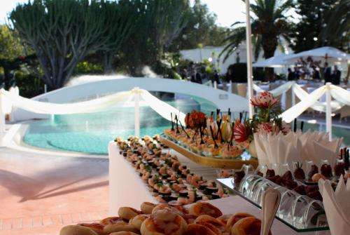 a buffet of food next to a swimming pool at Hotel Terme Villa Teresa in Ischia