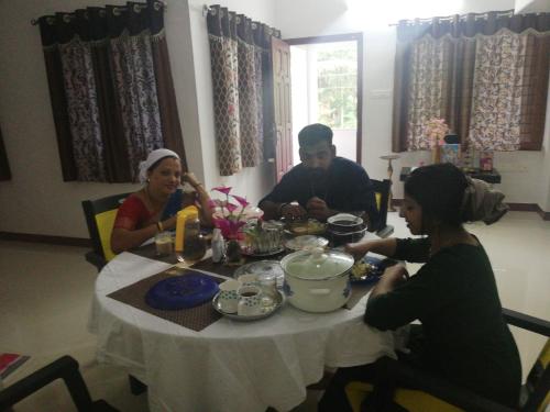 a group of people sitting around a table at Takashi Homestay North Paravur Near Muziris in North Paravur