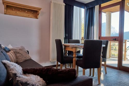 a living room with a table and chairs at Shackleton Chalet in Sestriere