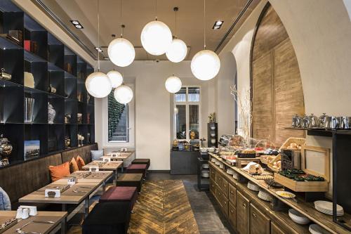 a restaurant with long tables and lights at Rome Times Hotel in Rome