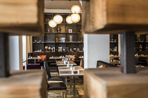 a dining room with tables and chairs and lights at Rome Times Hotel in Rome