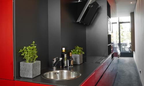 a bathroom with a sink and a red counter at Living Hotel Frankfurt in Frankfurt/Main