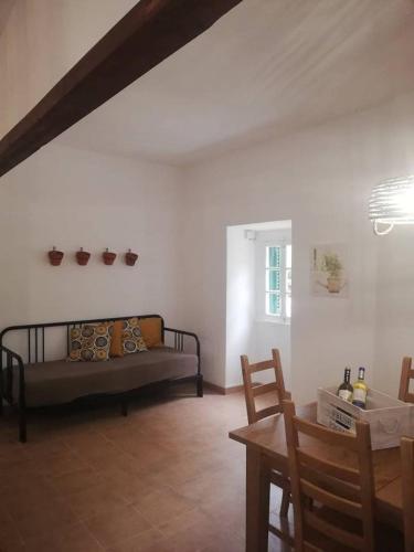 a living room with a couch and a table at Montejunto Villas - Casa do Plátano in Cadaval