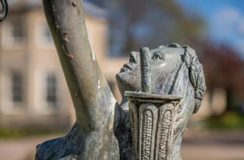 a statue of a frog holding a branch at Washingborough Hall Hotel in Lincoln