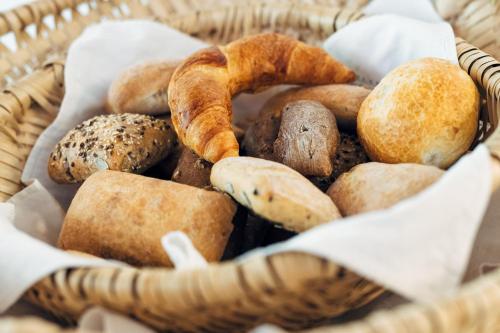 a basket filled with different types of bread at Wellnesshotel Engadin in Samnaun