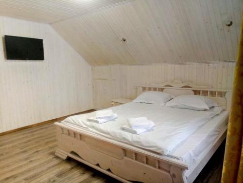 a bedroom with a large bed in a attic at VULYK z MEDOM in Bukovel