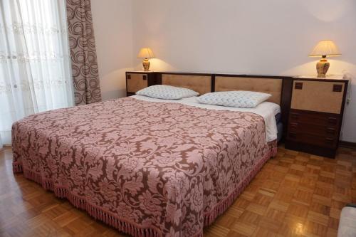 a bedroom with a large bed and two pillows at Mariella in Bašanija