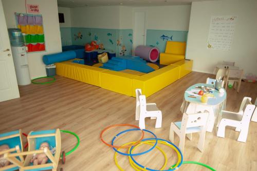a toy room with a couch and a table and chairs at King Solomon Hotel Tiberias in Tiberias