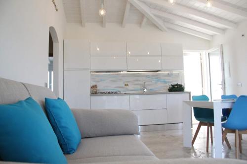 a living room with a couch and a table at R House Budoni in Budoni