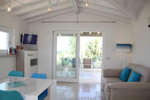 a living room with a couch and a table at R House Budoni in Budoni