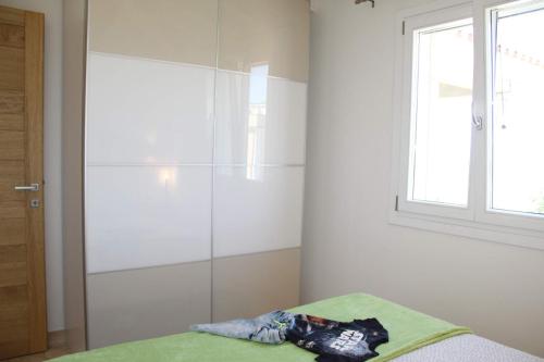 a bedroom with a glass shower in the corner at R House Budoni in Budoni
