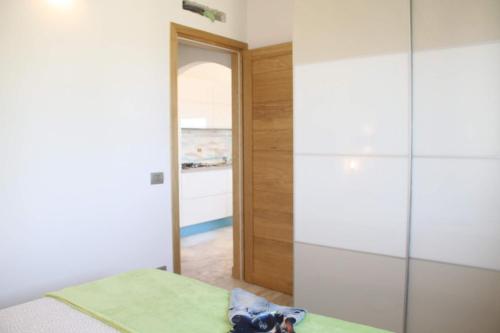 a bedroom with a bed and a glass closet at R House Budoni in Budoni
