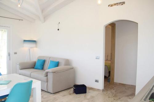 a living room with a couch and a table at R House Budoni in Budoni