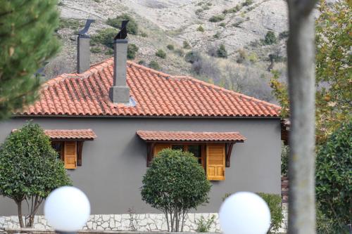 a white house with a red roof at Orias Guesthouse & Farm in Kalavrita