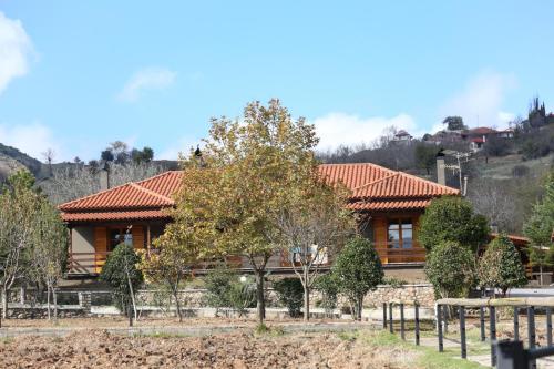 a house with a red roof at Orias Guesthouse & Farm in Kalavrita