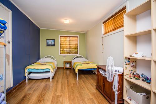 a room with two beds and a window at The Gee Beach House in Guilderton