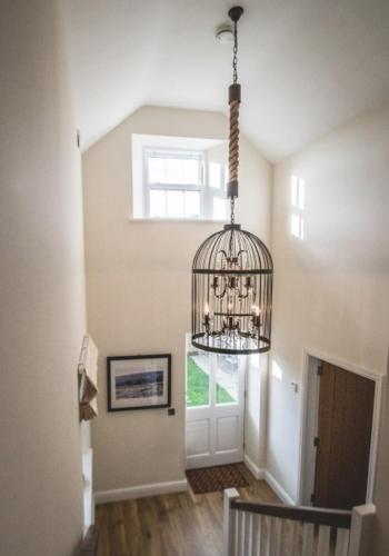 a chandelier hanging from a ceiling in a hallway at The Saddle Room in Middleham