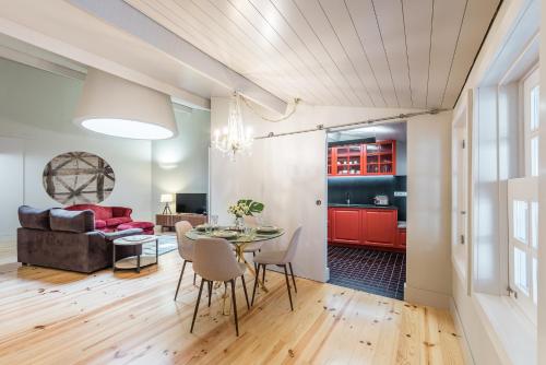 a living room with a table and a couch at Casa da Cera da Porta da Vila in Guimarães