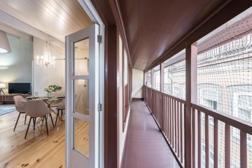 a hallway with a dining room and a dining table at Casa da Cera da Porta da Vila in Guimarães