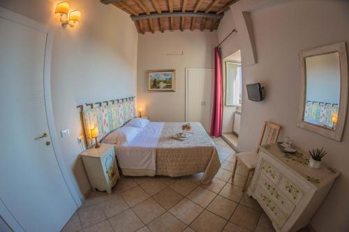 a bedroom with a bed and a table in a room at I Terzi Di Siena - Rooms Only in Siena