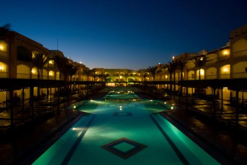a swimming pool filled with lots of lights and lots of umbrellas at Bel Air Azur Resort (Adults Only) in Hurghada
