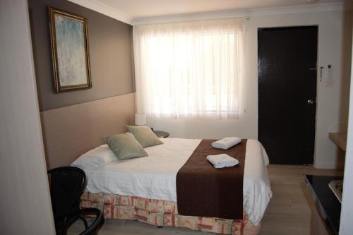 Ένα ή περισσότερα κρεβάτια σε δωμάτιο στο Civic Motor Inn