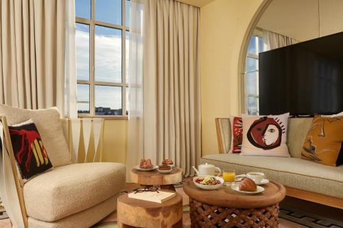 a living room with a couch and a tv at 9Confidentiel in Paris