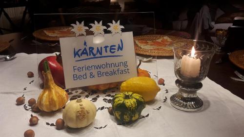 a table with a sign that says karmen performing bed and breakfast at Appartements im Park in Krumpendorf am Wörthersee