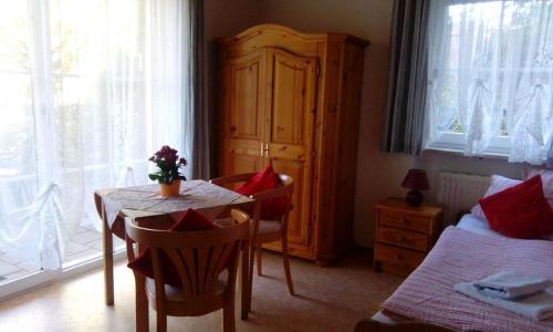 a bedroom with a table and a bed and a table and chairs at Ferienwohnung Hopfennest in Bischofsgrün