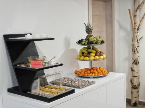 a buffet with three tiers of fruit on display at Aparthotel Centar Sarajevo in Sarajevo