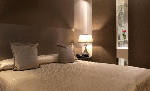 Ein Bett oder Betten in einem Zimmer der Unterkunft Hotel MiM Sitges & Spa