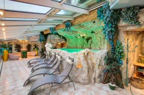 a group of chairs in front of a water wall at Boutique-Hotel Bauer in Saalbach Hinterglemm