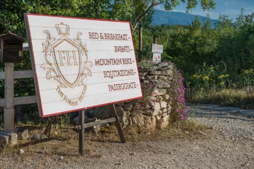 a sign that is on the side of a road at The Forest House in Isernia