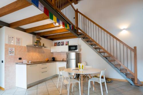 a kitchen and dining room with a table and a staircase at CAMP 4 in Arco