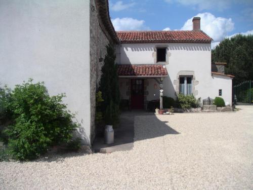 a white house with a pathway leading up to it at Chambre d'hôte du Plessis in Beaurepaire